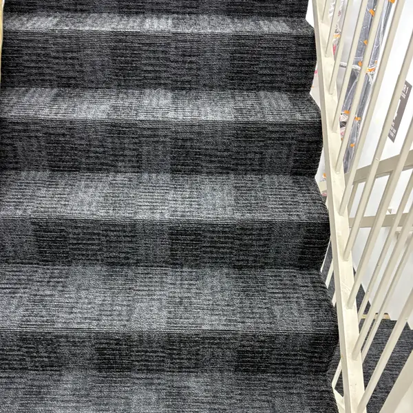 Navy tonal-pattern carpet with a clean landing — Dream Space Remodel flooring job