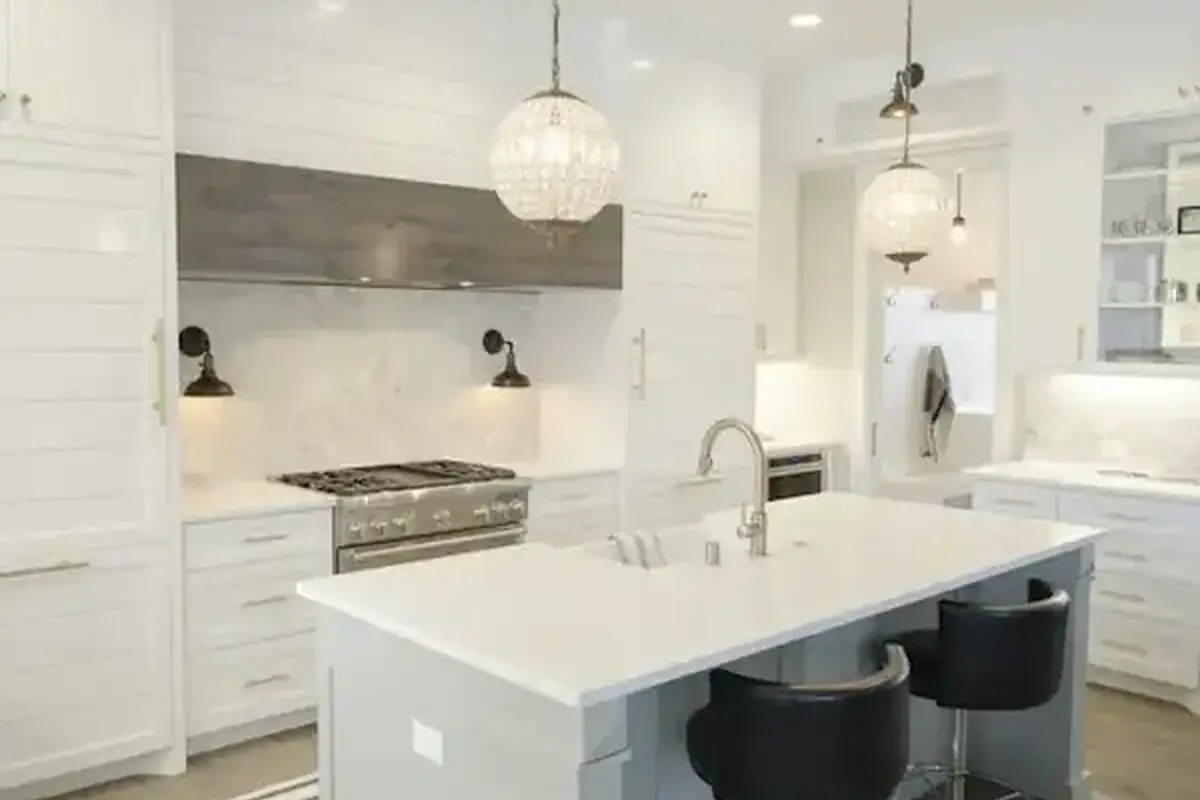 Bright white kitchen with an island and pendant lights