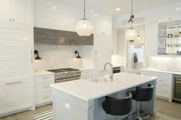 Bright white kitchen with an island and pendant lights