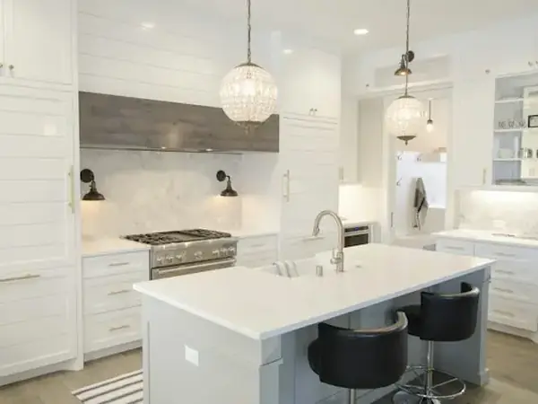 Bright white kitchen with an island and pendant lights