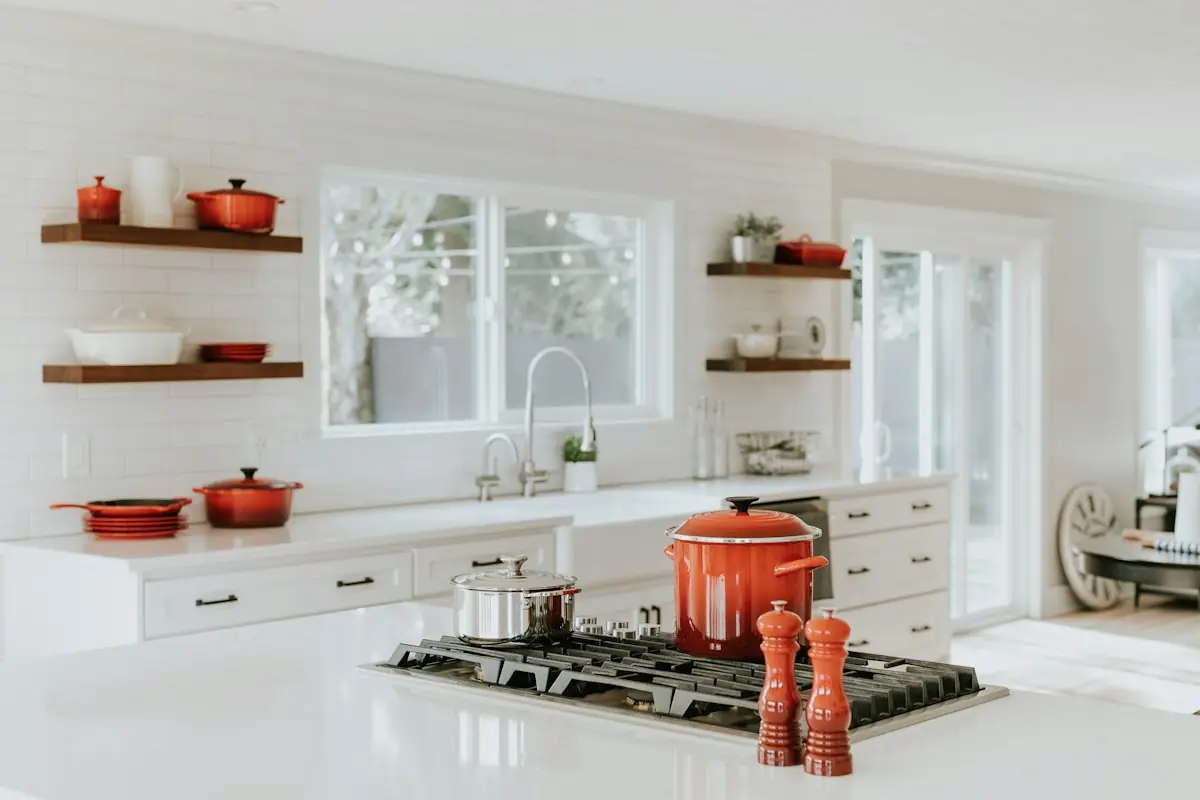 Modern kitchen with white cabinets, open shelving, and quartz countertops