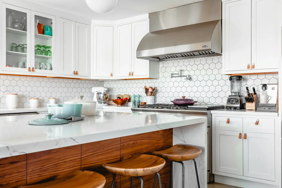 Kitchen with a wood island and white cabinets