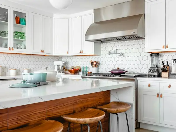 Kitchen with a wood island and white cabinets