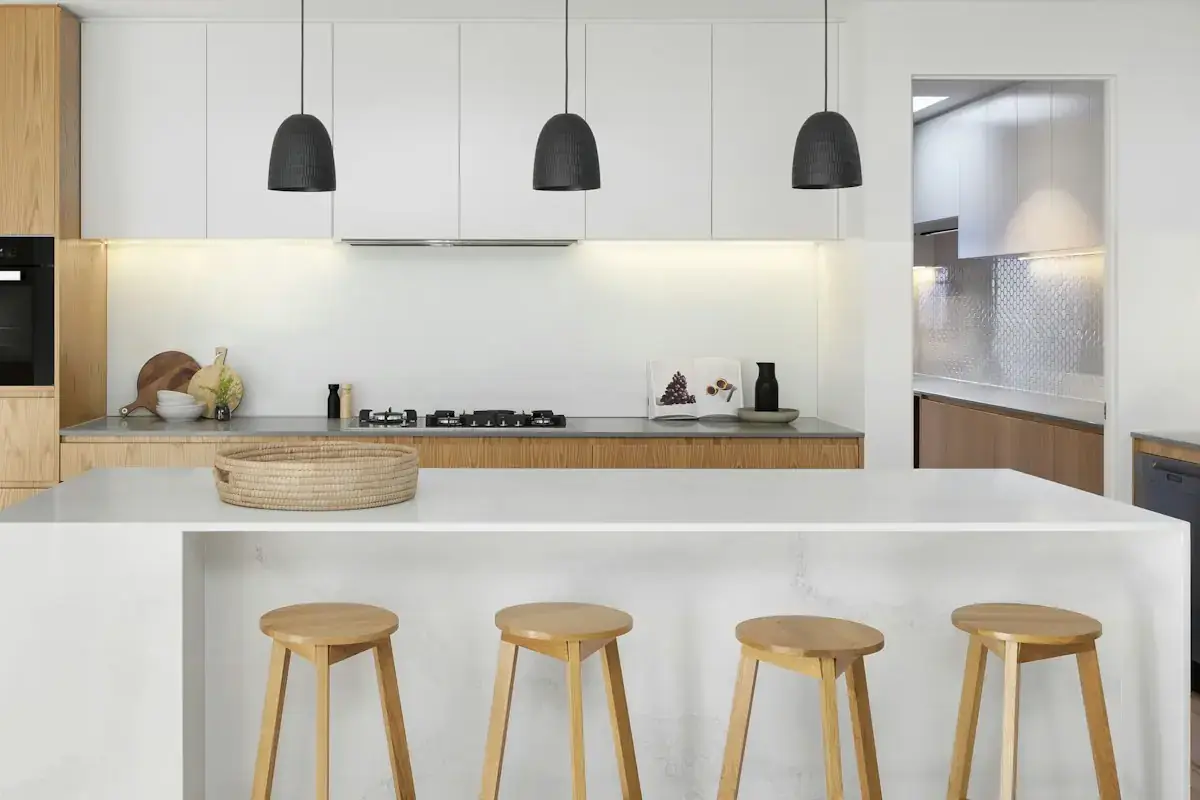 Contemporary kitchen with a wood island and pendant lights